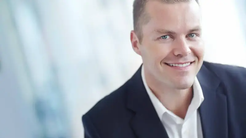 An image of a smiling man. Elevated Networks offers client-focused management solutions.