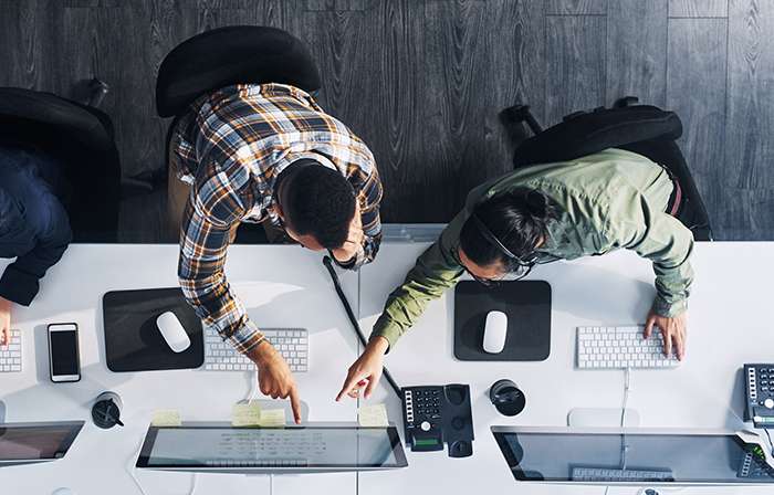 Two people in the office looking at a computer screen